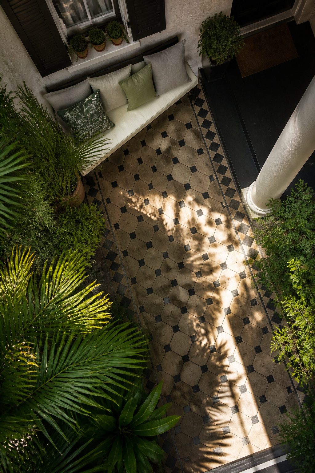 Pretty Porches: Designs and Details for Outdoor Living 7 A diagonal porch with plants and a narrow entryway.