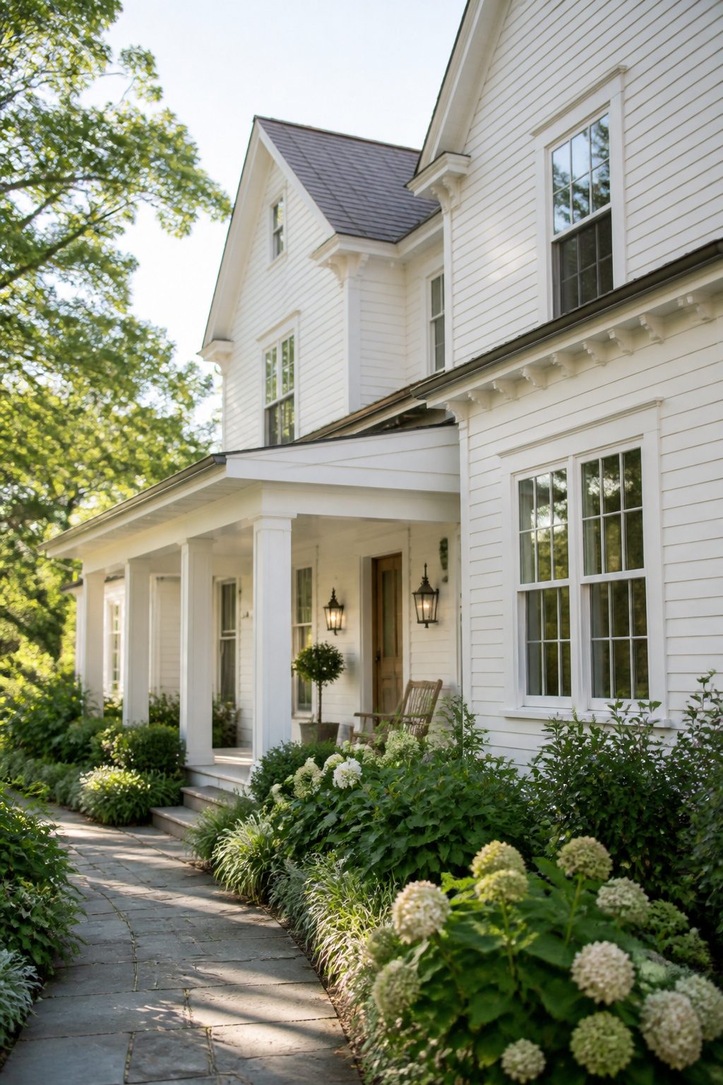 House in Benjamin Moore China White with a flower garden and wood accents.